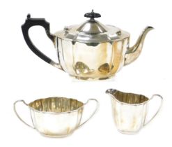 A George VI silver fluted three piece tea set, comprising teapot, cream jug and sugar bowl, Birmingh