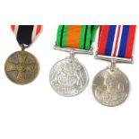 A WWII Third Reich War Merit Medal, with a War Merit Cross ribbon, together with a British Defence M