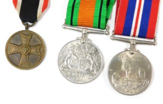 A WWII Third Reich War Merit Medal, with a War Merit Cross ribbon, together with a British Defence M