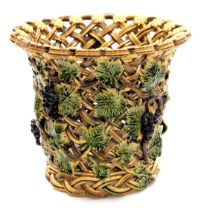 A late 19thC pottery basket, or wine cooler, of open lattice work form, moulded with repeating vines