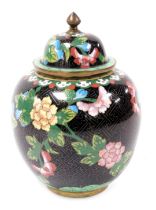 A Chinese cloisonne enamel jar and cover, decorated with peonies, on a black ground, 22.5cm high.