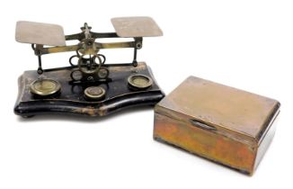 A set of Victorian brass postal scales, on an ebonised base, with weights, 20cm wide. together with