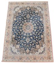 A Belgian style blue ground rug, decorated with floral and foliate motifs, with in repeating floral