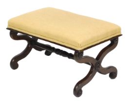 A Victorian rosewood stool upholstered in overstuffed yellow fabric, raised on X framed supports uni