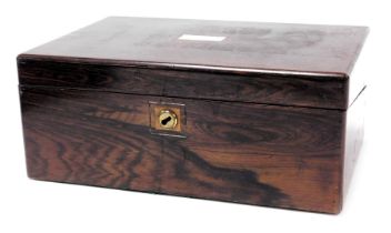 A Victorian rosewood writing slope, with a mother of pearl escutcheon, opening to reveal a fitted in