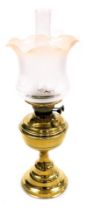 An early 20thC duplex brass oil lamp, with a glass chimney and frosted frilled glass shade, 56cm hig