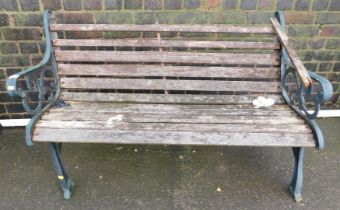 A wooden slatted garden bench, with green painted metal ends. (AF)