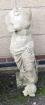 A reconstituted stone garden ornament of Venus, head detached.