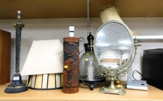 Ornamental lamps and a decorative mirror on stand.