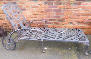 A cast metal garden sun lounger.