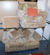 A sofa suite, comprising two seater floral upholstered sofa, armchair and a footstool.