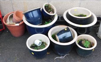 A group of garden pots, comprising black glazed examples, terracotta planters, etc. (a quantity)