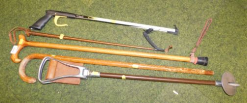 Various walking sticks, fruit picker and a shooting stick.