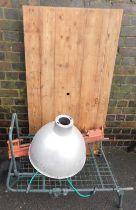 A galvanized ceiling light, pine slatted table, pull along trolley and a bench.