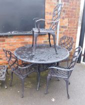 A cast metal and black finish circular garden table and four chairs.