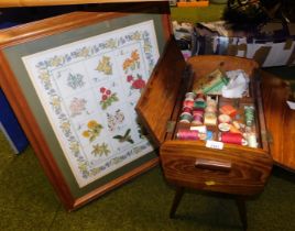 A needlework box and a framed and glazed needlework picture.