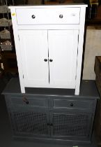 A white chest of single drawer over two doors and a black chest of two drawers over two panel doors.
