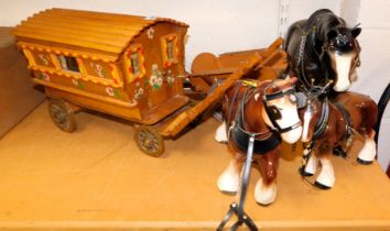 A small model of a Romany style caravan, a small cart and three ceramic horses (one AF).