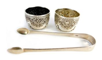 A pair of Victorian silver open salts, each of circular form embossed with part fluted decoration, s