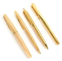 A group of Parker pens, each in gold coloured casing, comprising a fountain pen and two ballpoint pe