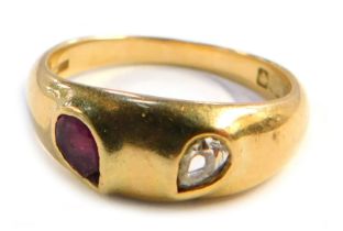 An Edwardian 18ct gold gypsy ring, set with pear cut ruby and diamond stones, Birmingham 1909, size