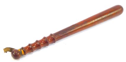 A 19thC turned wooden truncheon, with partial leather strap, 40.5cm long.