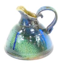 A Rebecca Harvey studio pottery jug, with a scroll handle and silver lustre blue and pale green glaz