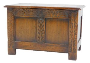 An oak small coffer, the rectangular top with a moulded edge enclosing a vacant interior, the panell