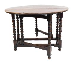 A 19thC oak gate leg dining table, raised on turned supports united by a box stretcher, 76cm high, 1