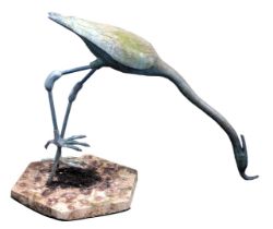 A garden sculpture modelled as a heron, in resin, on a composition base, 74cm high.