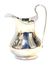 A George V silver cream jug, with a raised line rim, of baluster form, Birmingham 1922, 5.26oz, 12cm