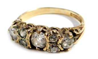 A 9ct gold diamond dress ring, set with seven imitation diamonds, possibly CZs, size N 1/2, 3g