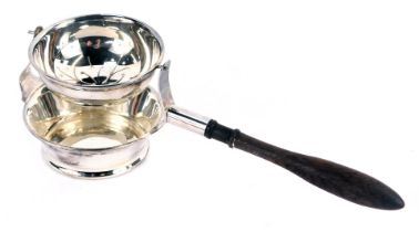 An Elizabeth II silver swinging tea strainer, with a pierced floral upper bowl and a turned wooden h