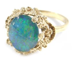 A 9ct gold opal dress ring, with oval doublet mounted in a cast mount, size P, 4.2g all in.