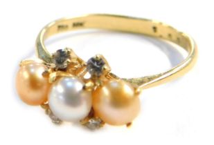 A pearl and diamond dress ring, with three bi-colour pearls, in a yellow metal shank stamped 750 &