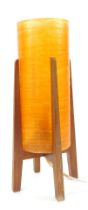 A mid century atomic table lamp, with circular orange plastic cylindrical shade, mounted in a teak s