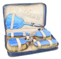 A George V silver and blue guilloche enamel dressing table set, comprising hand mirror (mirror plate