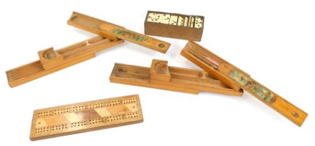 Two early 20thC wooden pencil boxes, bone dominoes, and a cribbage board. (4)