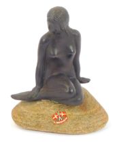 A Danish cast metal figure modelled as The Little Mermaid, on rock base with applied Kobenhavn trans