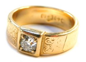 A Victorian two colour 18ct gold gentleman's diamond solitaire ring, with floral chased shoulders an