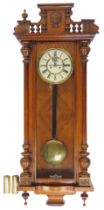 A mahogany cased Vienna regulator wall clock, with cream enamel dial bearing Roman numerals, brass c