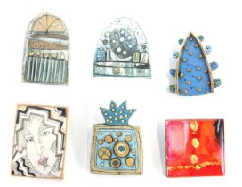 Four ceramic brooches by David Ashby, and two others. (6)