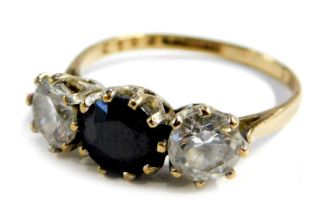 A 9ct gold three stone dress ring, set with a central round brilliant cut sapphire, flanked by two C