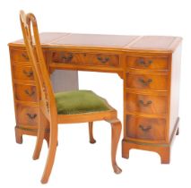 A reproduction mahogany breakfront twin pedestal desk, the top with gilt tooled brown leather three