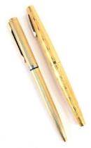 A Sheaffer fountain pen, in gold coloured casing, with bark type decoration, 14k nib, together with