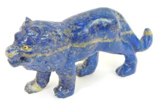 A 20thC lapis lazuli carved figure of a lion, in standing pose, 9cm high.