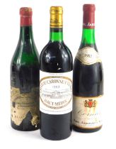 A bottle of Chateau Caronne Ste Gemme 1983 Haut-Medoc red wine, bottle of Cornas 1982 red wine, and