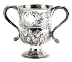 A George III silver loving cup, the top band embossed with a vacant cartouche and dog in landscape a