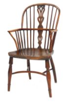 An early 19thC elm and yew wood Windsor chair, with a pierced splat, solid saddle seat stamped MARSH