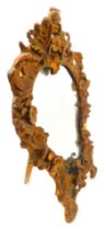 A 19thC gilt gesso rococo style strut mirror, decorated with scrolls, flowers, bows, etc., 48cm high